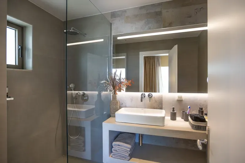 Modern bathroom with walk-in shower and illuminated mirror