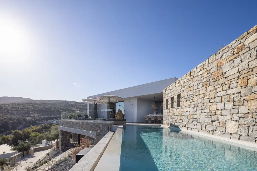 Villa ANDRIOTIS with infinity pool and natural stone wall by day