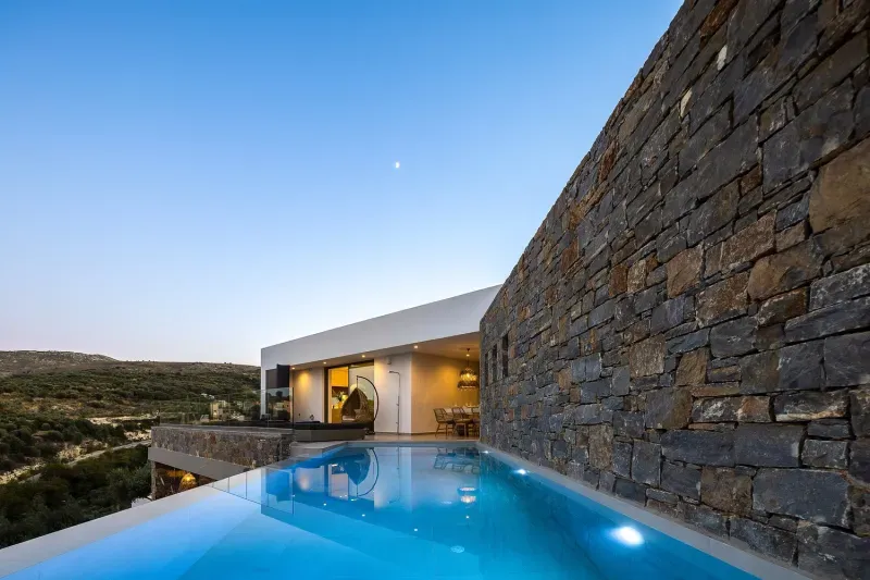 Villa ANDRIOTIS with its illuminated infinity pool at dusk